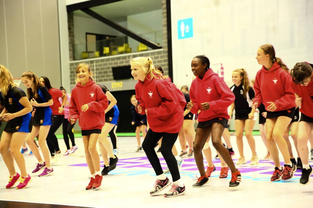 Children engaging with netball Children engaging with netball