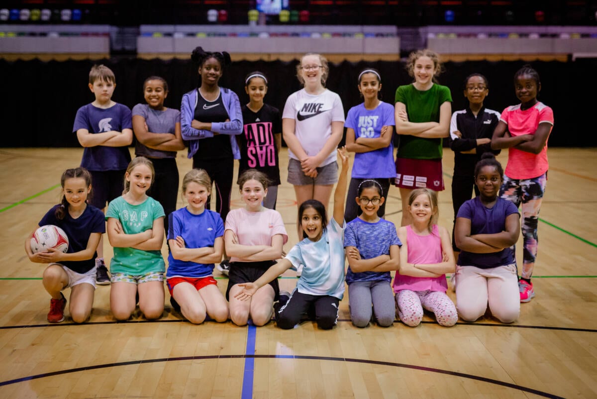 Group of children that play netball Group of children that play netball