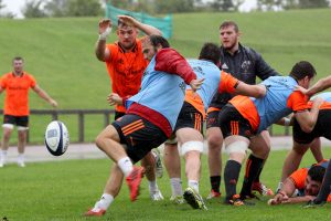 Duncan Williams with the box-kick under pressure from Sean McCarthy.