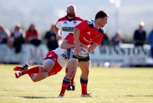 Luke O'Dea looks for the offload in the tackle