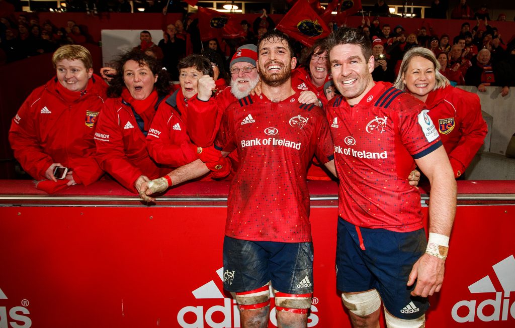 Billy Holland and Jean Kleyn celebrate with the MRSC Choir at full-time.