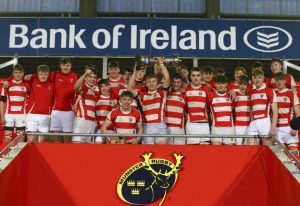 Skibbereen captain Jamie O'Driscoll lifts the Munster U18 Cup with teammates.