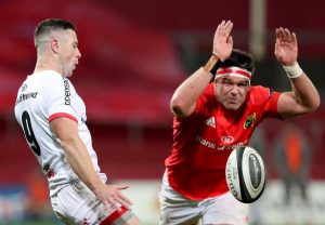 Billy Holland attempts to block a kick by John Cooney.