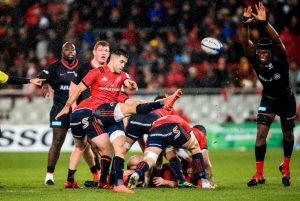 Conor Murray box kicks under pressure from Maro Itoje.