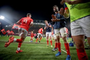 The Munster team run onto the pitch.