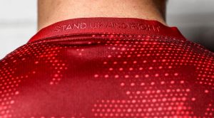 Stand Up And Fight embossed on the back of the jersey.