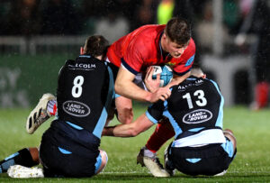 Jack O'Donoghue is tackled by Jack Dempsey and Robbie Fergusson.