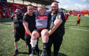 Norah Kelleher is carried on the pitch to celebrate with her teammates by Keith Simcox and Rob Keane