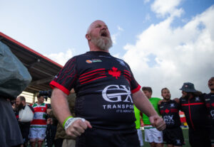 Jeff Stralak leads a chant of “O Canada” after the game