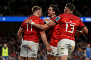Liam Coombes celebrates after scoring a try with Joey Carbery and Dan Goggin.