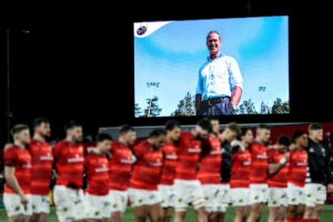 The teams stand for a minute's silence for Tom Tierney.