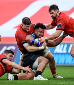 Jack Crowley, Jack O’Donoghue and Diarmuid Barron tackle Sione Vailanu.
