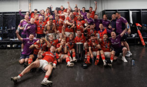 The Munster squad celebrate in the dressing room.