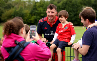 Tom Ahern poses for a photo with a young fan.