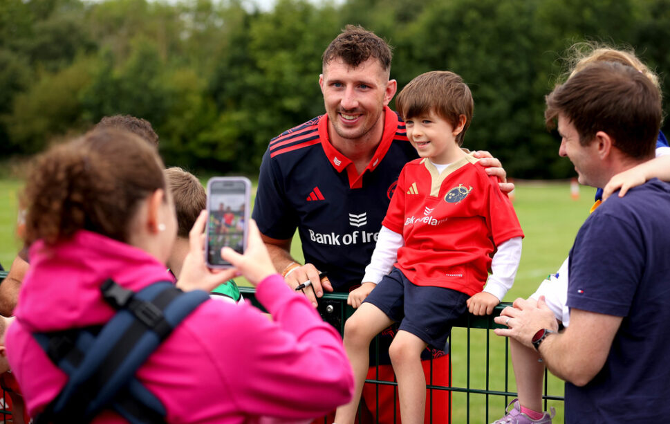 Tom Ahern poses for a photo with a young fan.