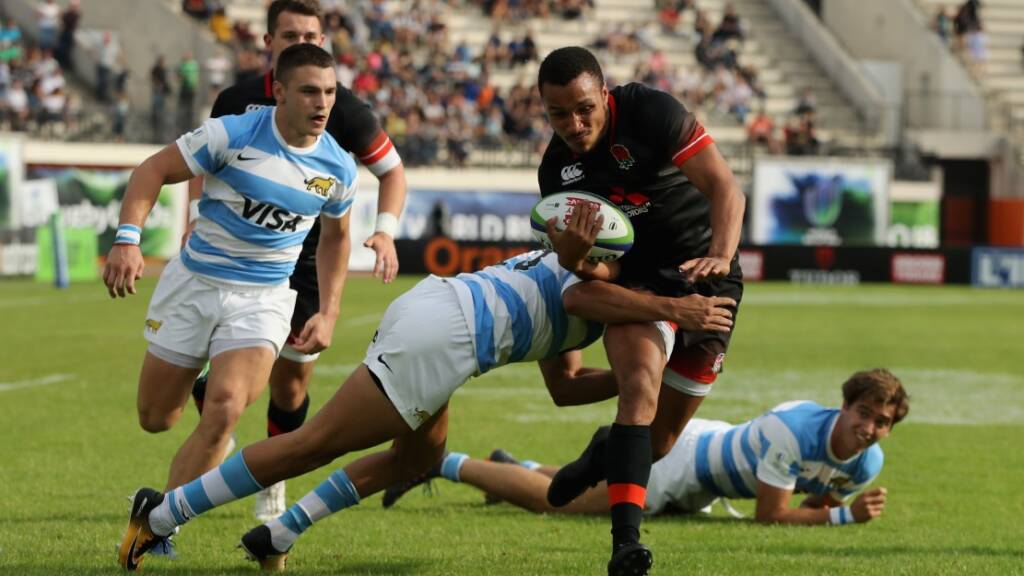 Jordan Olowofela of England breaks clear to score a try